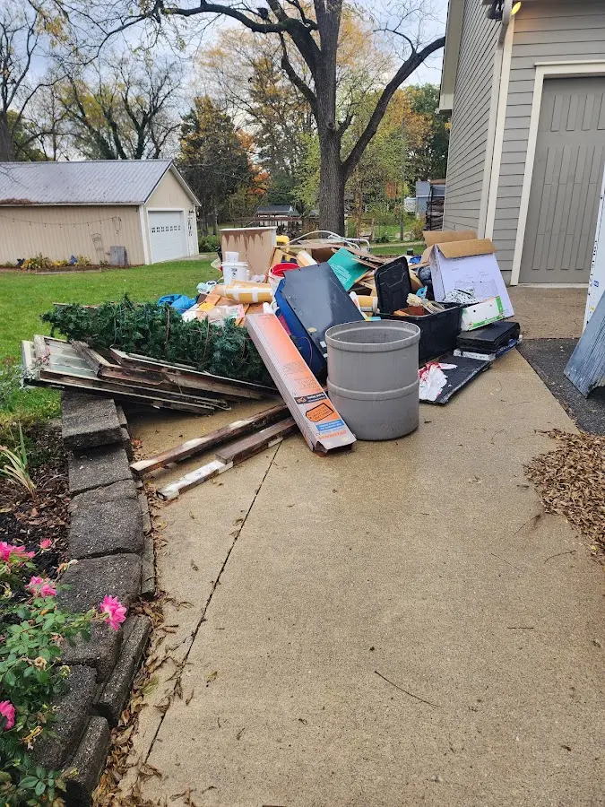 Dumpster being loaded with debris for 3 Yard Dumpster Rental in Midland Park